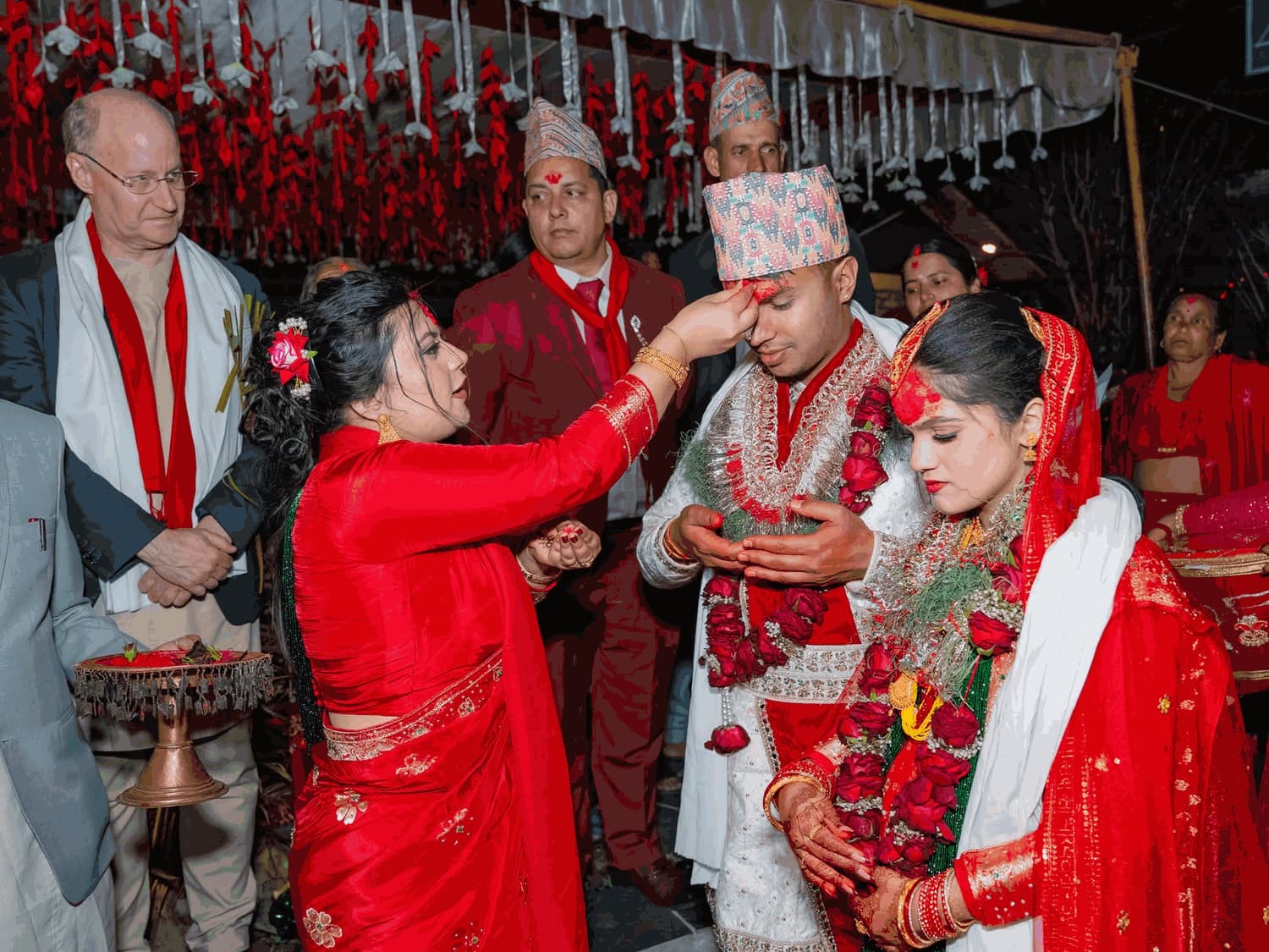 Jon Lund looking on as Suman receives tika at his and Sadikshya’s wedding